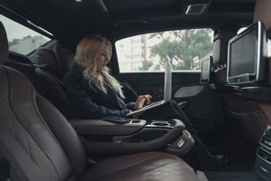 a woman using a laptop in a car