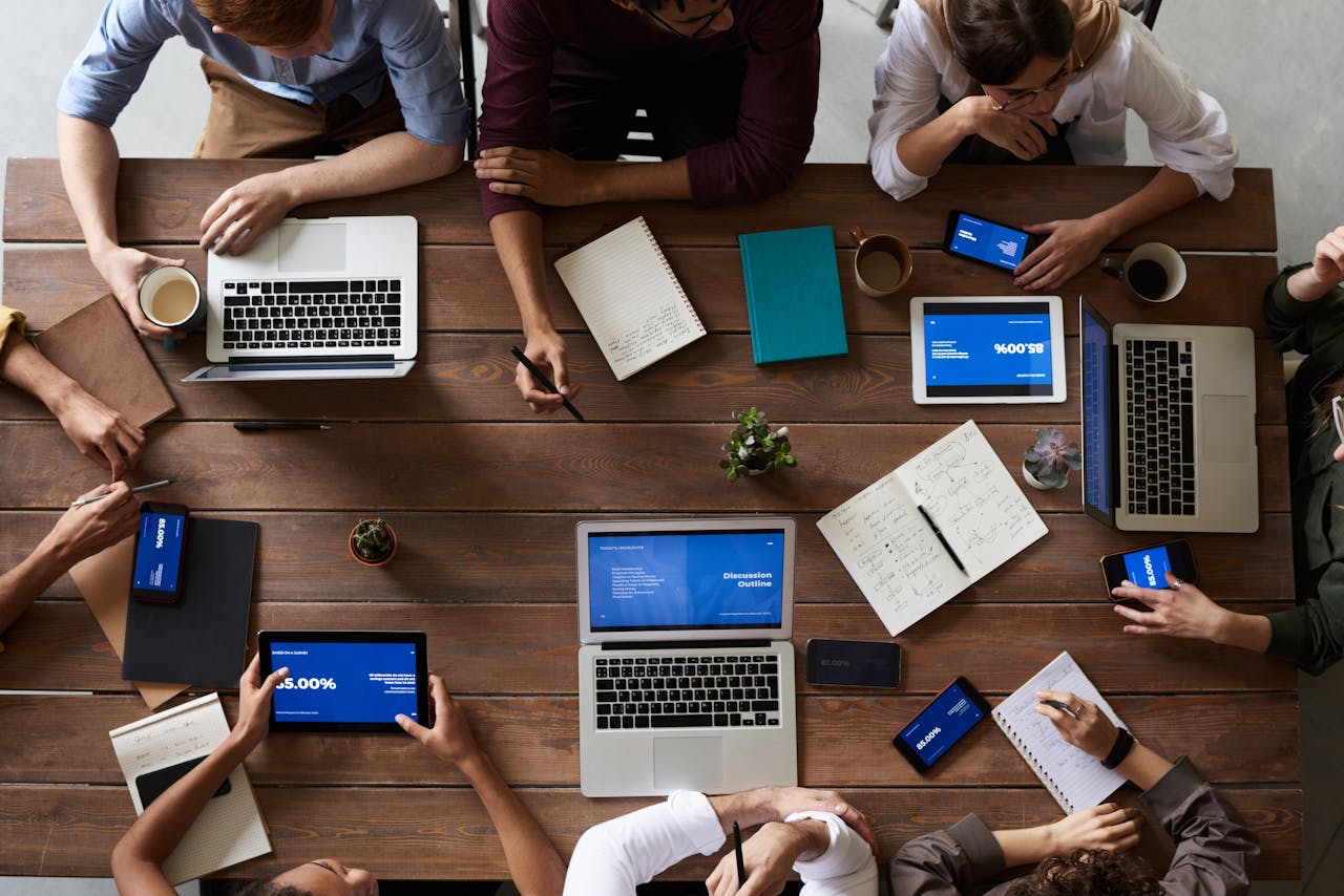 a table with laptops and notebooks